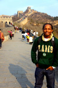 A CSU student stands in front of the Great Wall of China