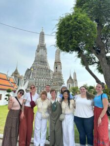 A group of CSU students standing in front of a temple in Thailand