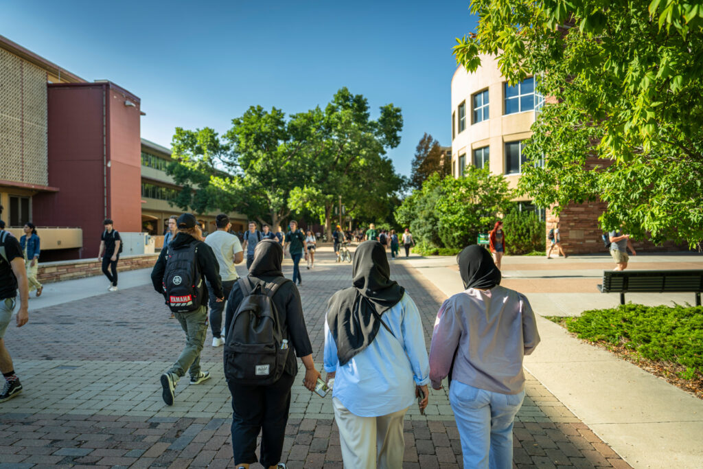 Three students walking through campus on the first day of classes at Colorado State University