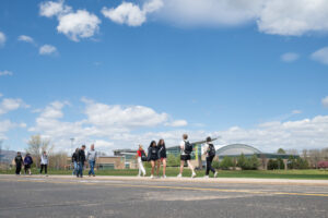 Students walk in front of the CSU Rec Center during a sunny day on campus.
