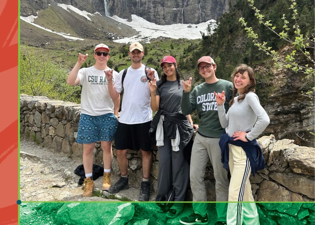 A photo of five students in nature wearing Colorado State gear and holding up their fingers to indicate Rams Horns