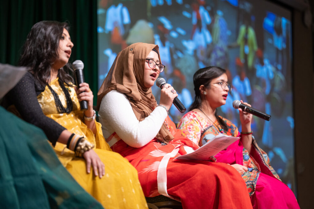 a panel of international students speaks on stage at the World Unity Fair