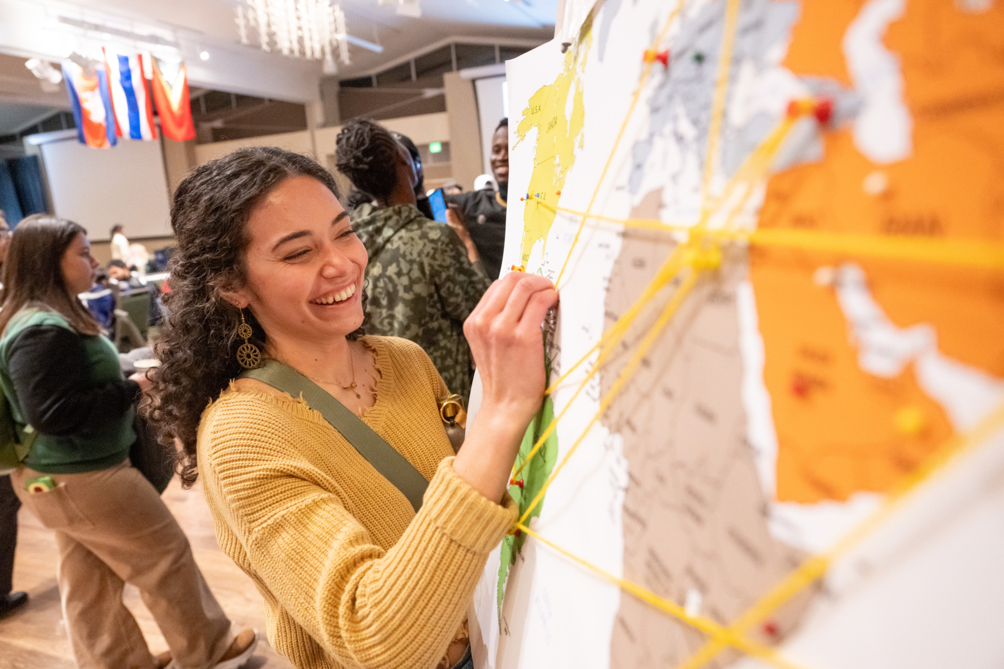 A world unity fair attendee puts a pin on a map
