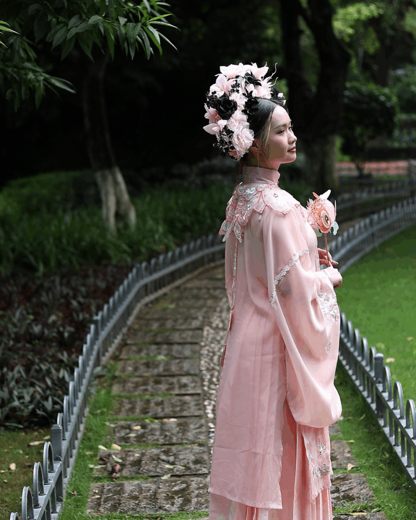 A woman in traditional Japanese garb walks along a garden path