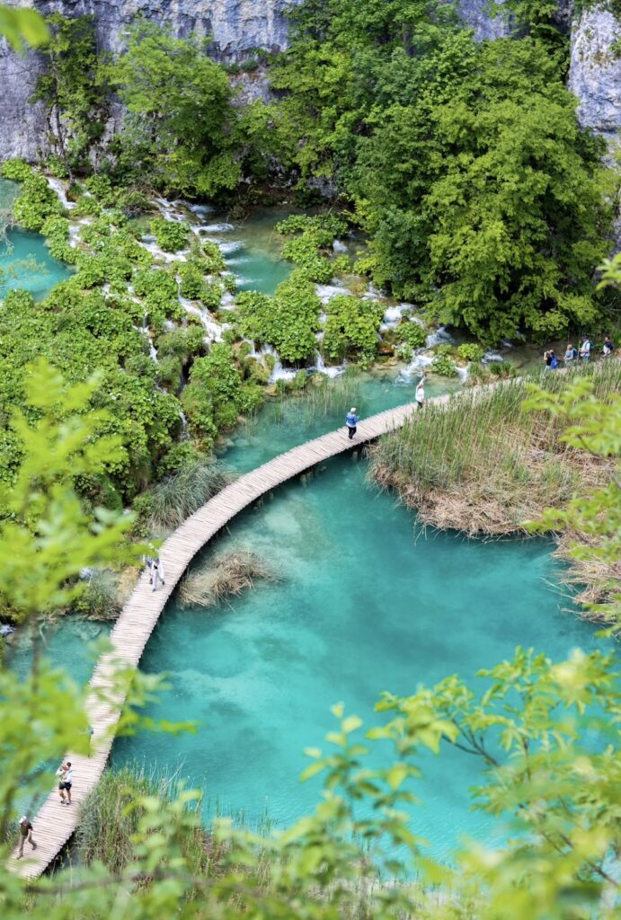 Aerial capture of turquoise water with a bridge running across