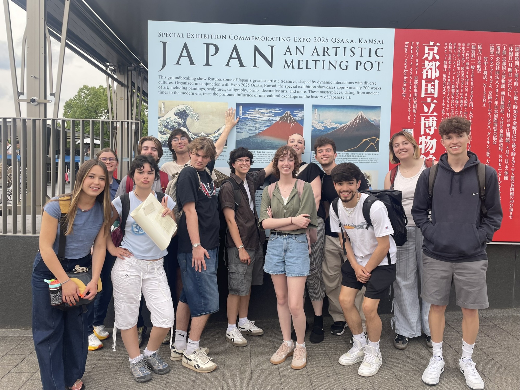 Students pose by an Art sign in Japan