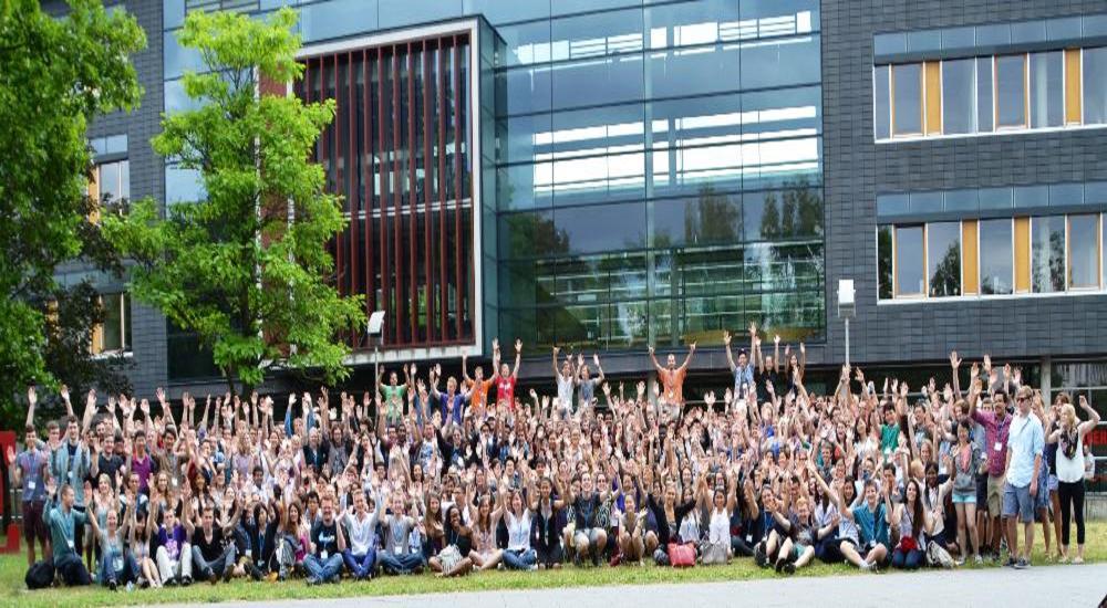 A large group of students in front of a new building