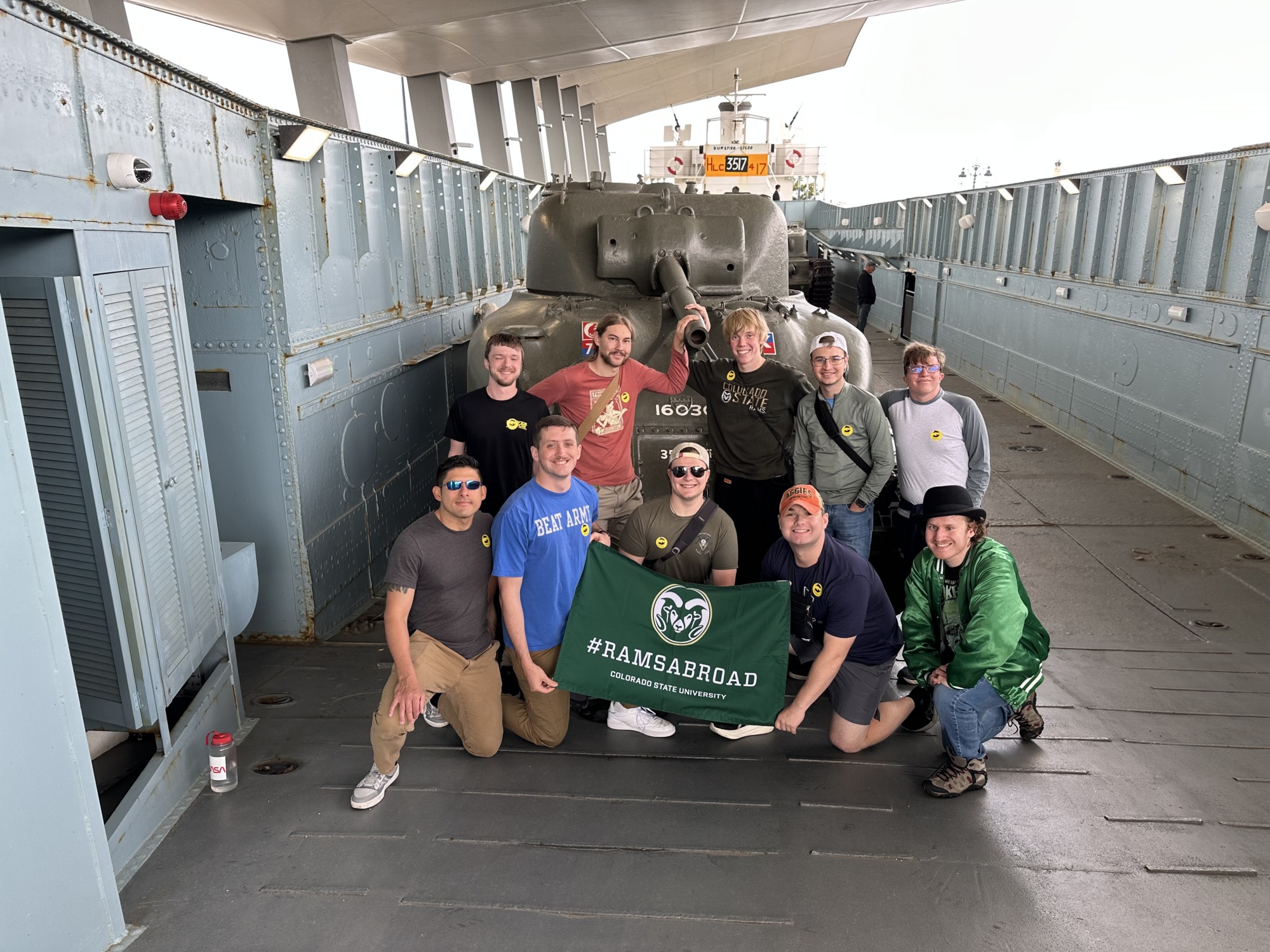 Students by an army tank