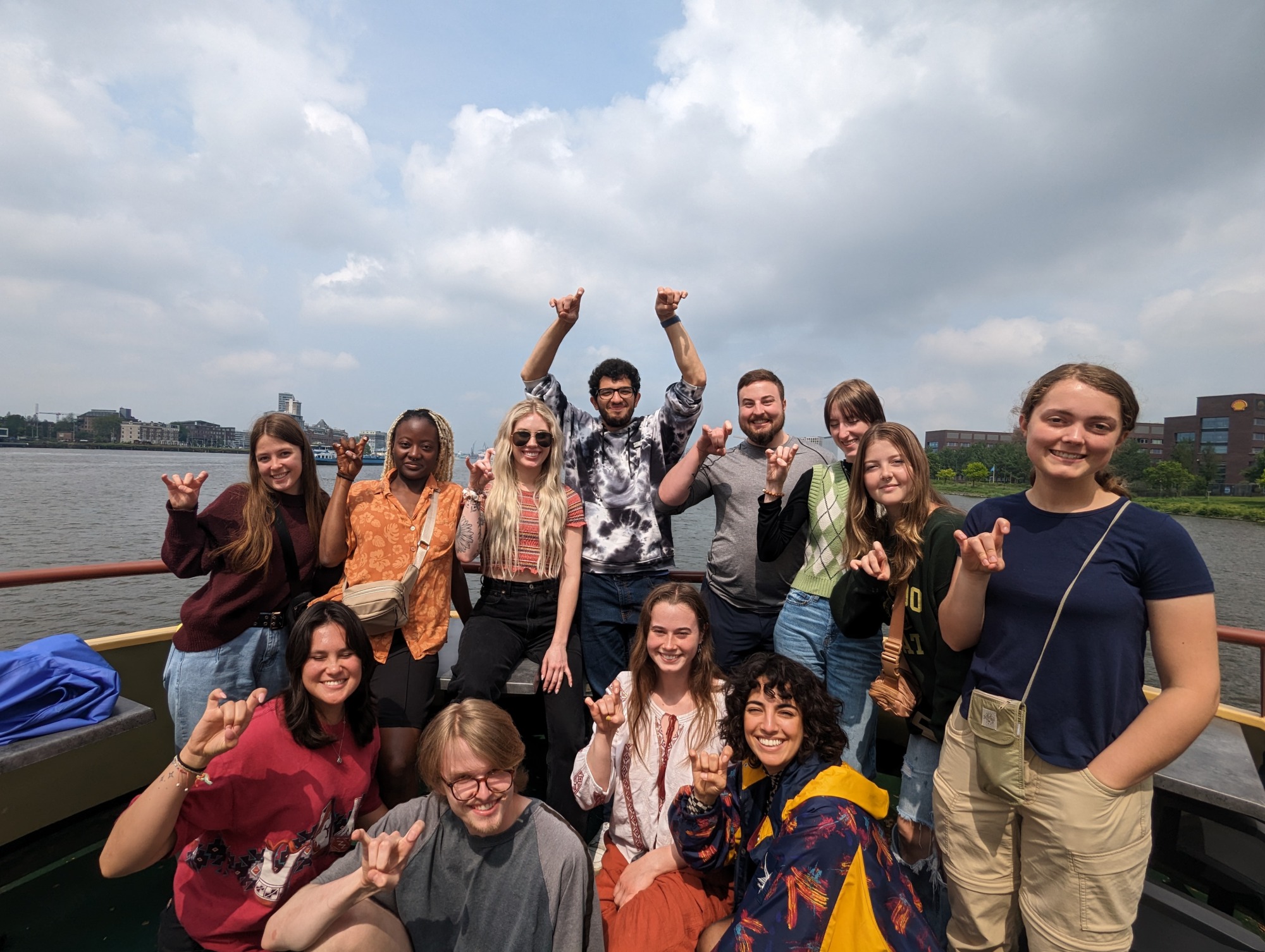 A group photo of students holding up their hands to make a rams horn symbol
