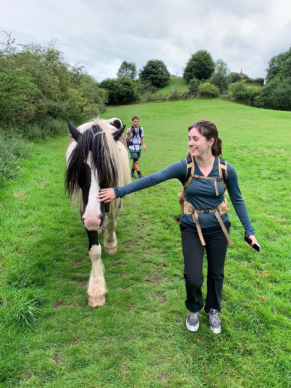 A student walking with a donkey