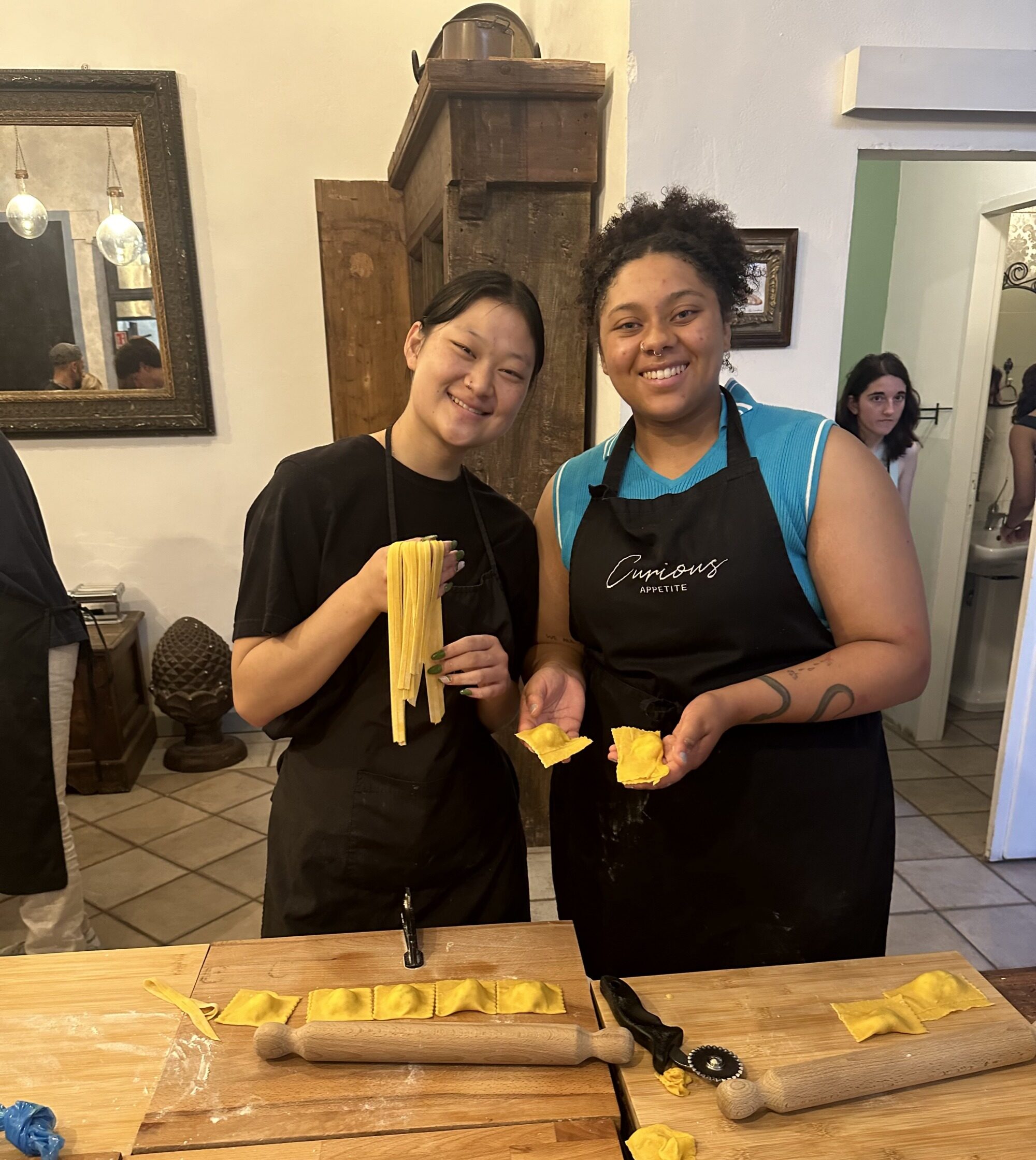 Two girls making pasta