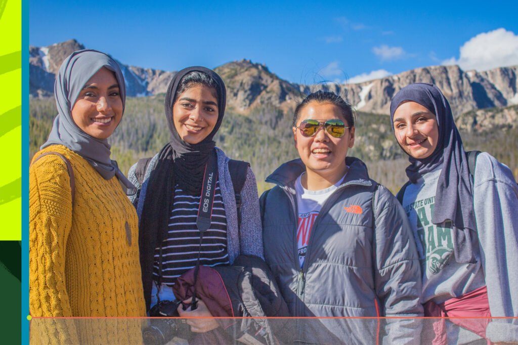 Four international students with mountains in the background