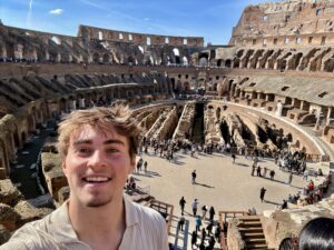 A student in front of the Colosseum in Rome