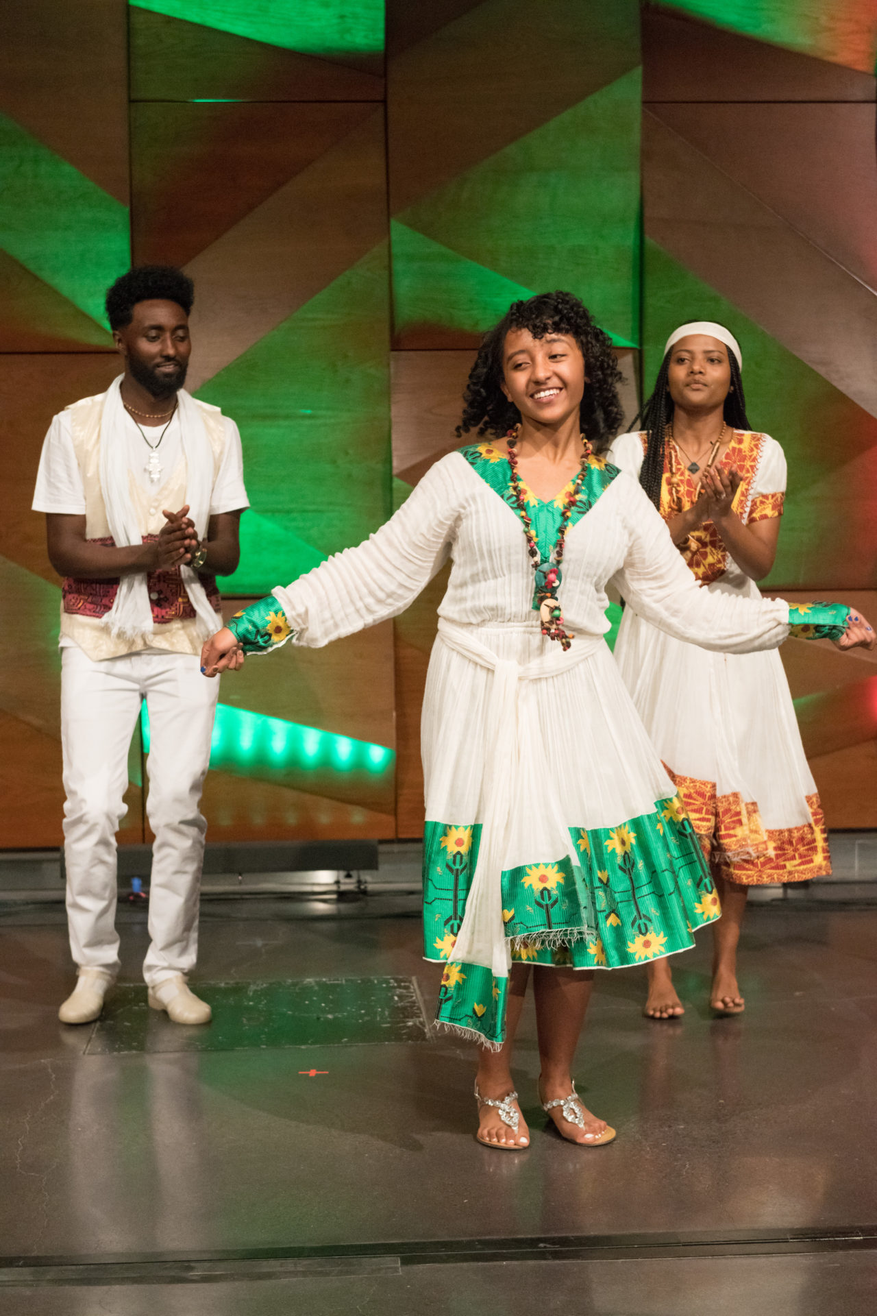 three people from Ethiopian student organization dancing