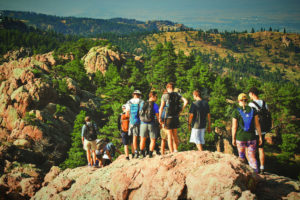 students hiking along rocky terrain