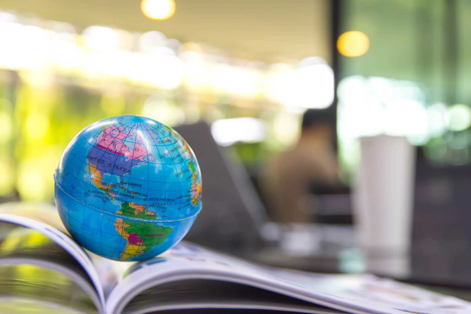 A globe of the Earth sitting on top of an open book